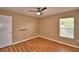 Bedroom with wood-look flooring, a ceiling fan, and ample natural light at 154 Canna Dr, Davenport, FL 33897
