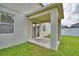 View of a home's covered patio and backyard area, showcasing the outdoor living space at 154 Canna Dr, Davenport, FL 33897