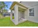 Covered patio with view to a screened in pool and green backyard at 154 Canna Dr, Davenport, FL 33897