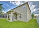Exterior of home with a patio, lush lawn, and fenced backyard at 154 Canna Dr, Davenport, FL 33897