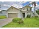 Lovely two-story home with manicured landscaping, a two-car garage, and a welcoming entrance at 154 Canna Dr, Davenport, FL 33897
