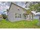 Backyard exterior view showcases the home, patio, and well-maintained lawn at 154 Canna Dr, Davenport, FL 33897