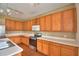 The spacious kitchen is equipped with white countertops, wooden cabinets, and modern stainless steel appliances at 154 Canna Dr, Davenport, FL 33897