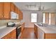 The well-appointed kitchen includes ample cabinetry, modern appliances, and a breakfast bar with sink at 154 Canna Dr, Davenport, FL 33897