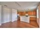 Open-concept kitchen with wood cabinets, stainless steel appliances, and a breakfast bar for casual dining at 154 Canna Dr, Davenport, FL 33897