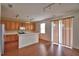 Kitchen with wooden cabinets and stainless steel refrigerator open to dining area, brightened by natural light at 154 Canna Dr, Davenport, FL 33897