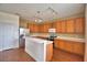 Well-lit kitchen with wooden cabinets, stainless steel appliances, and laminate floors at 154 Canna Dr, Davenport, FL 33897