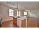 Bright kitchen boasts a sink, wooden cabinets, laminate floors, and stainless steel appliances at 154 Canna Dr, Davenport, FL 33897