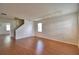 Spacious living room with wood laminate flooring, staircase, track lighting, and natural light at 154 Canna Dr, Davenport, FL 33897