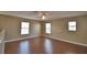 Spacious living room boasts wood floors, ample windows, and ceiling fan at 154 Canna Dr, Davenport, FL 33897