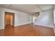 Open-concept living room with wood laminate flooring, access to bath, stairs, and neutral walls at 154 Canna Dr, Davenport, FL 33897