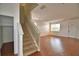 Open-concept living area featuring wood floors, staircase, and large windows at 154 Canna Dr, Davenport, FL 33897