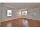 Bright living room with wood laminate flooring, track lighting, and large windows at 154 Canna Dr, Davenport, FL 33897