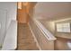 Carpeted stairway leading to an open room with modern track lighting and wood-look flooring at 154 Canna Dr, Davenport, FL 33897