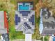 An aerial view shows a home equipped with solar panels and an enclosed pool and spa at 157 Golf Aire Blvd, Haines City, FL 33844