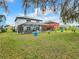 A huge backyard boasts a screened-in pool and spa, with plenty of room for play or pets at 157 Golf Aire Blvd, Haines City, FL 33844