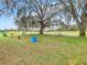 A spacious backyard and mature oak tree makes for a serene outdoor space at 157 Golf Aire Blvd, Haines City, FL 33844