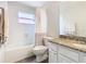 Bathroom featuring shower/tub, toilet, and vanity with granite counter and white cabinets at 157 Golf Aire Blvd, Haines City, FL 33844