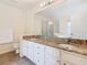 Bathroom showcasing granite countertops, a large mirror, and a glass-enclosed shower at 157 Golf Aire Blvd, Haines City, FL 33844