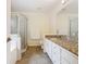 Bright bathroom featuring granite countertops, shower, and neutral-toned tile flooring at 157 Golf Aire Blvd, Haines City, FL 33844