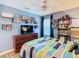 Bedroom featuring blue walls, hardwood floor and natural light with bookshelves at 157 Golf Aire Blvd, Haines City, FL 33844