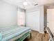 Bright bedroom featuring a window, closet, wood floors, and a single bed with striped bedding at 157 Golf Aire Blvd, Haines City, FL 33844