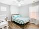 Bright bedroom featuring a window, desk, wood floors, and a full bed with striped bedding at 157 Golf Aire Blvd, Haines City, FL 33844