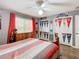 Bedroom with wood floors, dresser, and baseball decor at 157 Golf Aire Blvd, Haines City, FL 33844