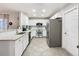 Bright kitchen featuring white cabinets, stainless steel appliances, and a breakfast bar with seating at 157 Golf Aire Blvd, Haines City, FL 33844