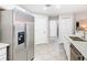 A spacious kitchen featuring stainless steel appliances, granite countertops, and tile floors at 157 Golf Aire Blvd, Haines City, FL 33844