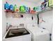 Practical laundry room featuring a washer, dryer, storage shelves, and room for laundry at 157 Golf Aire Blvd, Haines City, FL 33844