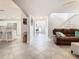 Open-concept living area featuring tile flooring and easy access to the front door and kitchen area at 157 Golf Aire Blvd, Haines City, FL 33844