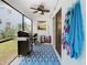 Relaxing covered patio featuring a grill, ceiling fan, and screened-in pool in the backyard at 157 Golf Aire Blvd, Haines City, FL 33844