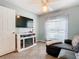 Sitting room with electric fireplace, wall-mounted TV, and window at 157 Golf Aire Blvd, Haines City, FL 33844