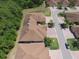 Aerial view shows roof tops with mature trees and shrubbery interspersed throughout the neighborhood at 1573 Vienna Square Dr, Winter Haven, FL 33884