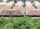 Scenic aerial view displays rooftops in a tranquil neighborhood, nestled among lush greenery and trees at 1573 Vienna Square Dr, Winter Haven, FL 33884