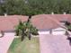 Aerial view of one-story homes featuring brick driveways, lush lawns, and mature landscaping at 1573 Vienna Square Dr, Winter Haven, FL 33884
