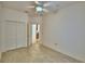 Bedroom features tile flooring, ceiling fan, and closet at 1573 Vienna Square Dr, Winter Haven, FL 33884