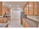 A spacious kitchen features stainless steel appliances, tile flooring, and plenty of cabinets at 1573 Vienna Square Dr, Winter Haven, FL 33884