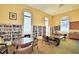 Library with walls of bookshelves, tables, and comfortable chairs for reading and relaxing at 1573 Vienna Square Dr, Winter Haven, FL 33884