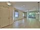 Open-concept living room with tiled flooring, natural light, and access to the lanai at 1573 Vienna Square Dr, Winter Haven, FL 33884