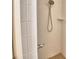 A tiled shower features a mounted shower head and grab bar for accessibility at 1573 Vienna Square Dr, Winter Haven, FL 33884