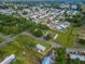 Expansive aerial view of a residential community, lush landscaping, and nearby lake at 1610 Reynolds Rd # 242, Lakeland, FL 33801