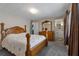 Comfortable main bedroom features a large bed, soft carpet, a dresser, and an ensuite bathroom at 1610 Reynolds Rd # 242, Lakeland, FL 33801