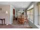 Cozy dining room features wood table, comfortable seating, chandelier, and large windows at 1610 Reynolds Rd # 242, Lakeland, FL 33801