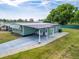 Aerial view of home with green siding and a covered driveway at 1610 Reynolds Rd # 242, Lakeland, FL 33801