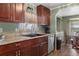 Well-lit kitchen with dark cabinets, stainless steel appliances, and tile countertops at 1610 Reynolds Rd # 242, Lakeland, FL 33801