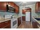 Bright kitchen featuring modern appliances, wood cabinets, and lots of storage space at 1610 Reynolds Rd # 242, Lakeland, FL 33801