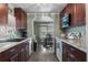 Open-concept kitchen and dining area featuring modern appliances and wood cabinets at 1610 Reynolds Rd # 242, Lakeland, FL 33801