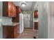 The kitchen features wood cabinets, tile countertops, a white refrigerator, and lots of storage at 1610 Reynolds Rd # 242, Lakeland, FL 33801
